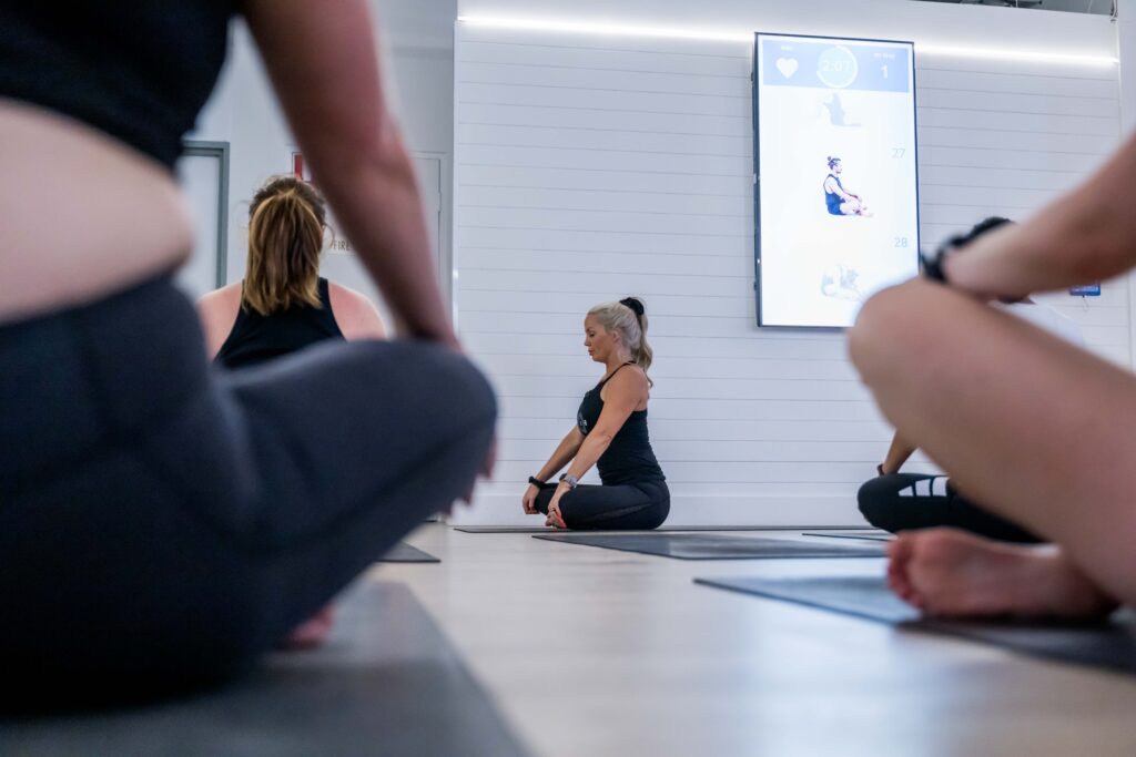 Woman in yoga pose in fitness studio.