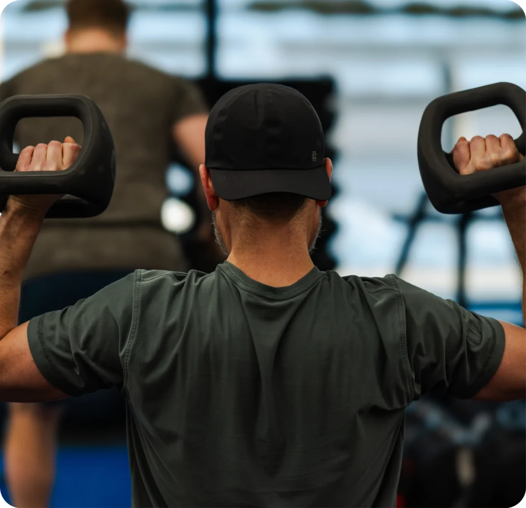Man doing shoulder exercises at an F45 workout